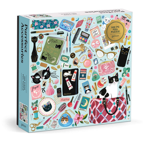 The Purrfect Accessories 500 Piece Foil Puzzle by Christine De Carvalho features colorful, whimsical illustrations of cat-themed accessories like sunglasses, cosmetics, notebooks, and playful cats.
