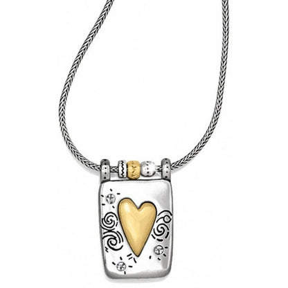 Brighton pendant necklace with brushed gold heart, silver-plated rectangular frame, and swirl engravings on a white background