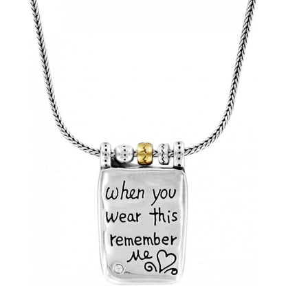 Brighton pendant necklace with engraved message, brushed gold bead accent, and silver-plated chain on a white background