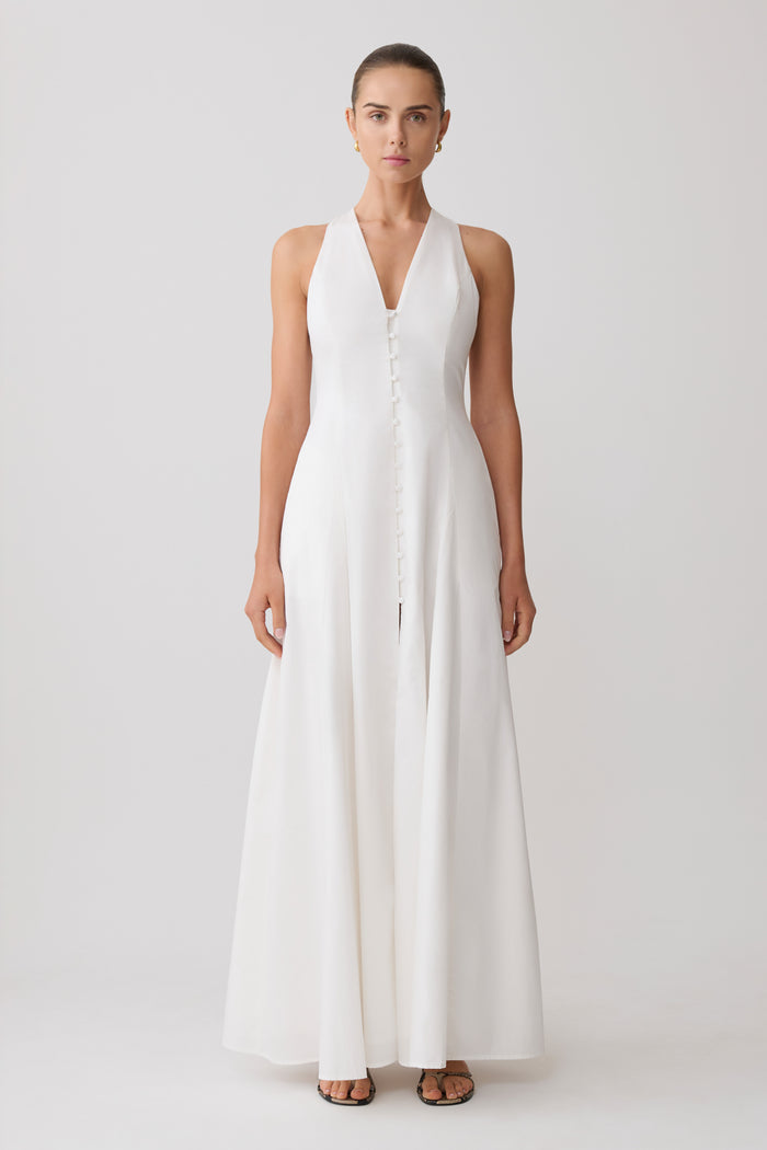Woman wearing a white sleeveless maxi dress.