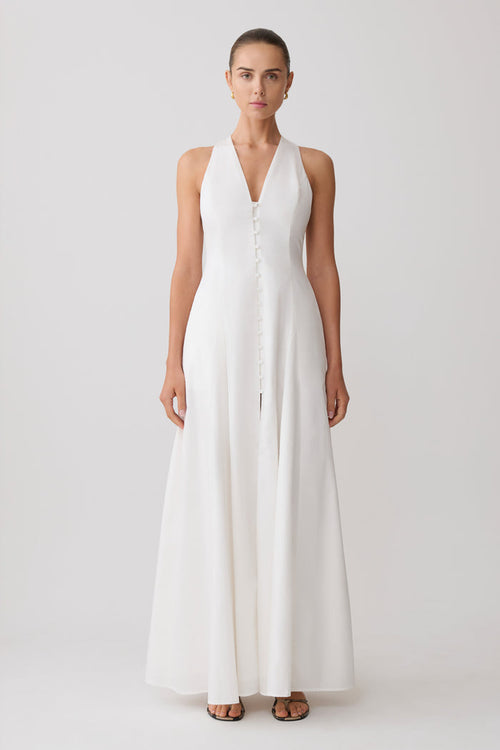 Woman wearing a white sleeveless maxi dress.