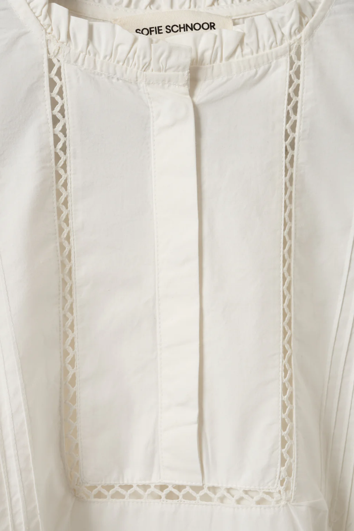 Close-up of white Sofie Schnoor Otaniasw Frill Cotton Dress S262147 with delicate lace trim, shop Sofie Schnoor at Dotique.
