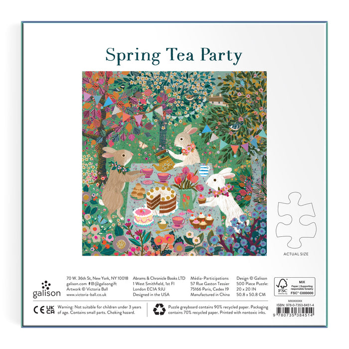 The Victoria Ball Spring Tea Party 500 Piece Foil Puzzle features woodland animals—a deer, rabbit, and fox—enjoying tea, cakes, and sweets at a whimsical garden table surrounded by flowers under a vibrant, leafy tree.