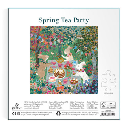 The Victoria Ball Spring Tea Party 500 Piece Foil Puzzle features woodland animals—a deer, rabbit, and fox—enjoying tea, cakes, and sweets at a whimsical garden table surrounded by flowers under a vibrant, leafy tree.