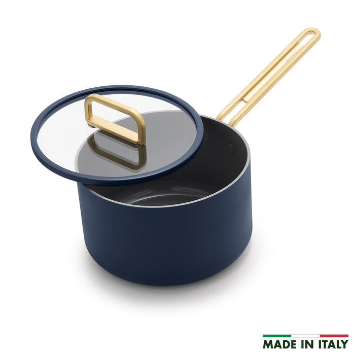 Blue ceramic saucepan with lid next to a Made in Italy label.