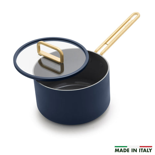 Blue ceramic saucepan with lid next to a Made in Italy label.