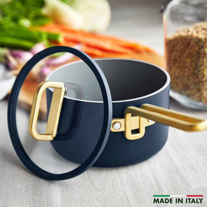 Ceramic nonstick 4-quart saucepan in marino blue with gold handle and lid.