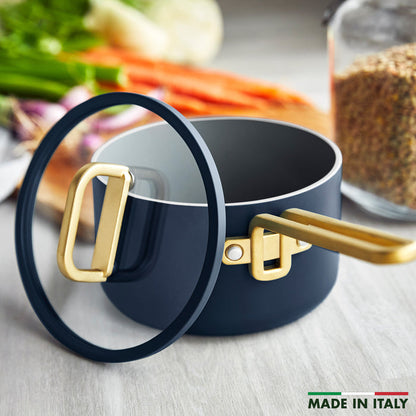 Ceramic nonstick 4-quart saucepan in marino blue with gold handle and lid.