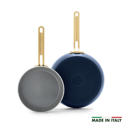 Two ceramic nonstick frypans in marino blue with gold handles and gray interiors, shown as an 8-inch and 10-inch set.