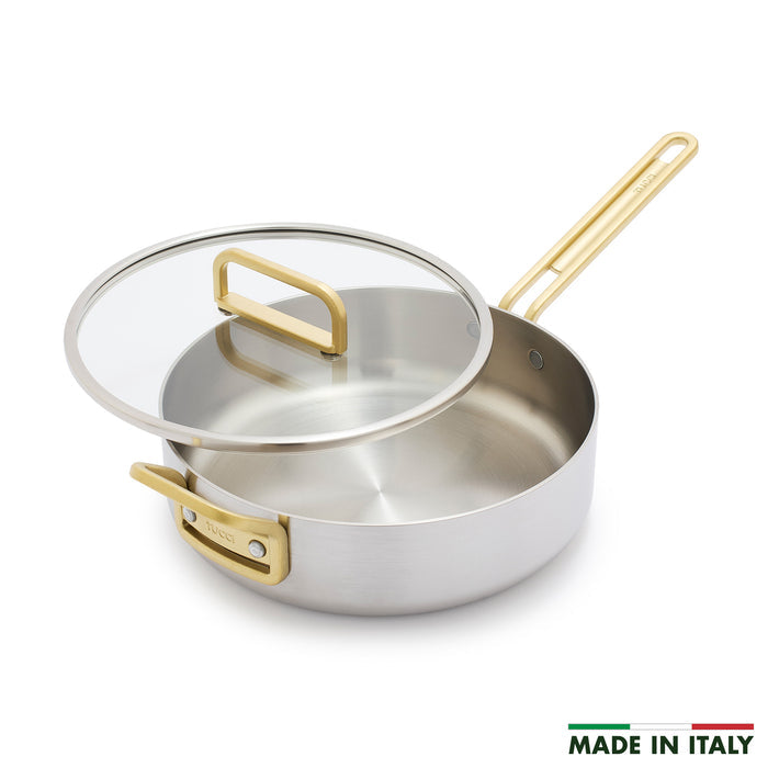 Stainless steel sauté pan with gold handle, glass lid, and “Made in Italy” text on the bottom right. 4-quart size.