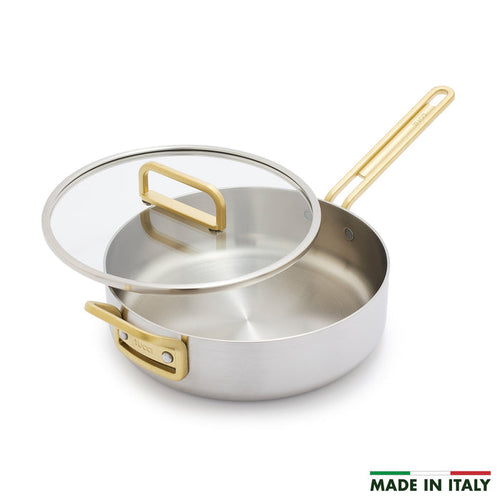 Stainless steel sauté pan with gold handle, glass lid, and “Made in Italy” text on the bottom right. 4-quart size.