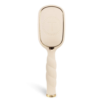 Gold paddle brush on a white background