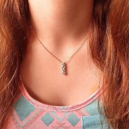 Tiny Super Sparkly Rock Candy Crystal Bar Necklace worn by a person with long hair, showcasing its delicate sparkle.