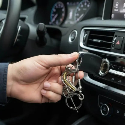 Wire Coiled Birdie Keychain For Him - Limited Edition in hand, attached to car keys, inside a vehicle's dashboard.