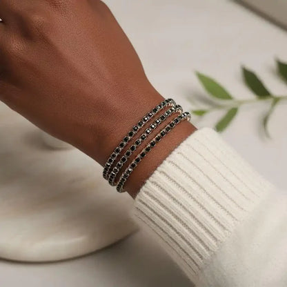 Wire Wrapped Copper Silver Black Crystal Rhinestone Bangle worn on a wrist with a sweater.