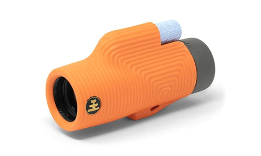 Orange monocular with a textured grip on a white background
